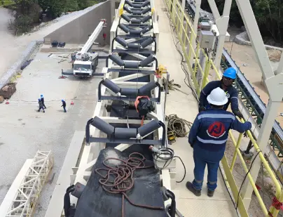 Ingenieros al lado de un sistema de bandas transportadoras